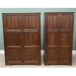 TWO PRIORY OAK-STYLE LADY'S & GENTS WARDROBES, having linenfold carved upper panels, ironwork hinges