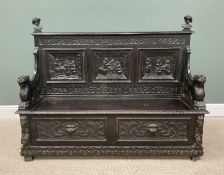 ANTIQUE STAINED OAK JACOBEAN-STYLE BOX SEAT HALL BENCH, with carved lion arms, tavern interior