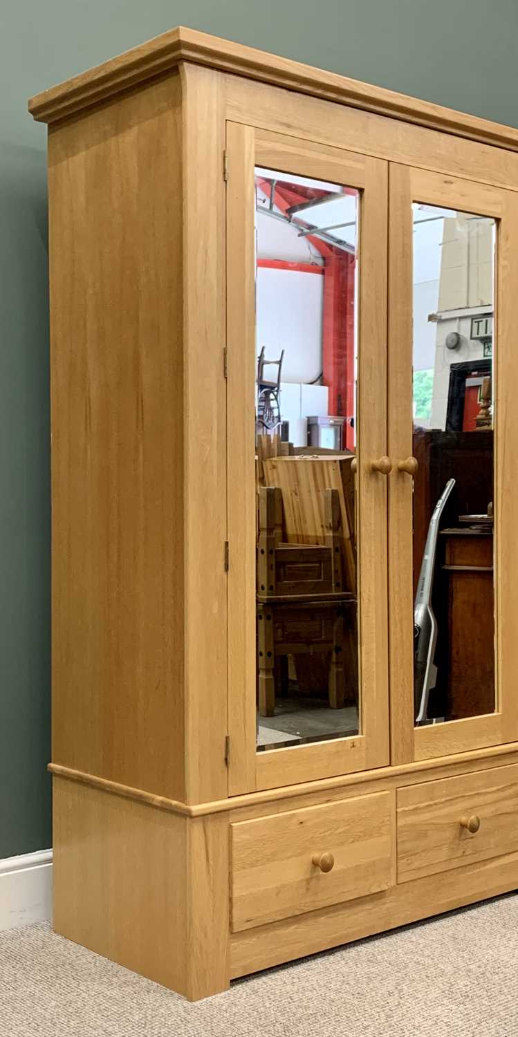 MODERN OAK DOUBLE WARDROBE, having twin upper bevelled edge mirrored doors over two lower drawers, - Image 4 of 6