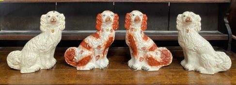 VICTORIAN STAFFORDSHIRE SEATED SPANIELS, 2 PAIRS, including a red and white pair, 31.5cms H, and a