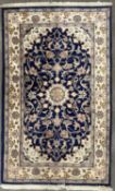 G H FRITH HANDMADE ORIENTAL BLUE GROUND RUG, with floral central block, multi-bordered edging and