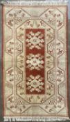 EASTERN STYLE RUG, cream and rust ground with full run repeating pattern border and central block,