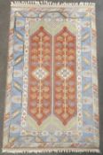 EASTERN STYLE WOOLLEN RUG, multi-coloured with central rust ground repeating pattern and multi-
