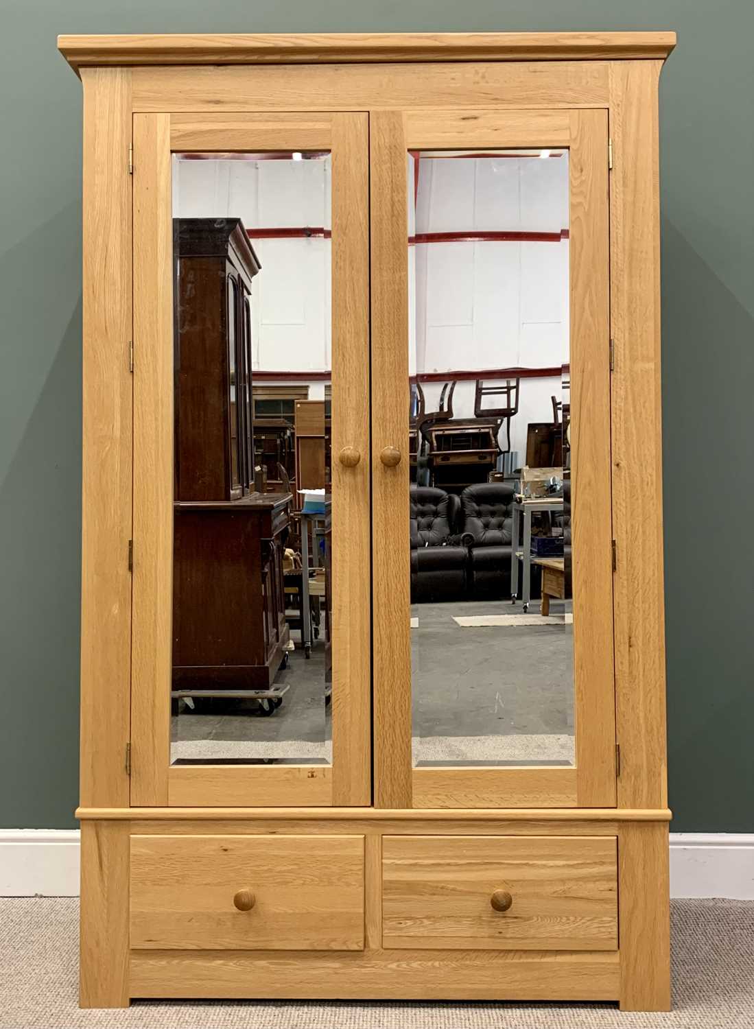 MODERN OAK DOUBLE WARDROBE, having twin upper bevelled edge mirrored doors over two lower drawers,