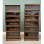 TWO GLOBE WERNICKE OAK SIX-SECTION STACKING BOOKCASES with top covers and single drawer bases,