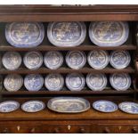 BLUE & WHITE WILLOW PATTERN POTTERY DRESSER SET, comprising 4 x 45cms across meat platters and 16
