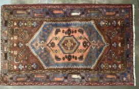 IRANIAN WOOLLEN RUG, brown and blue ground with central zig zag diamond motif and multi-pattern