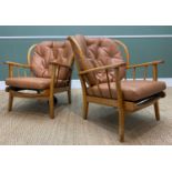 TWO MID-CENTURY ERCOL STYLE WINDSOR EASY ARMCHAIRS, tan faux leather upholstery, Pirelli rubber