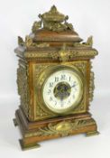 LATE VICTORIAN GILT METAL MOUNTED OAK BRACKET CLOCK, the circular dial with a cream enamel chapter