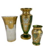 THREE BOHEMIAN GLASS VASES, heavily gilt panels applied with flowers, two in green glass, the