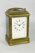 LATE 19TH CENTURY GILT BRASS REPEATING CARRIAGE CLOCK, the silvered platform stamped GV, corniche