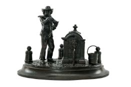 19TH C. BRONZE FIGURAL INKWELL, modelled with a drinking fountain beside a man with yoke,10.5cms h