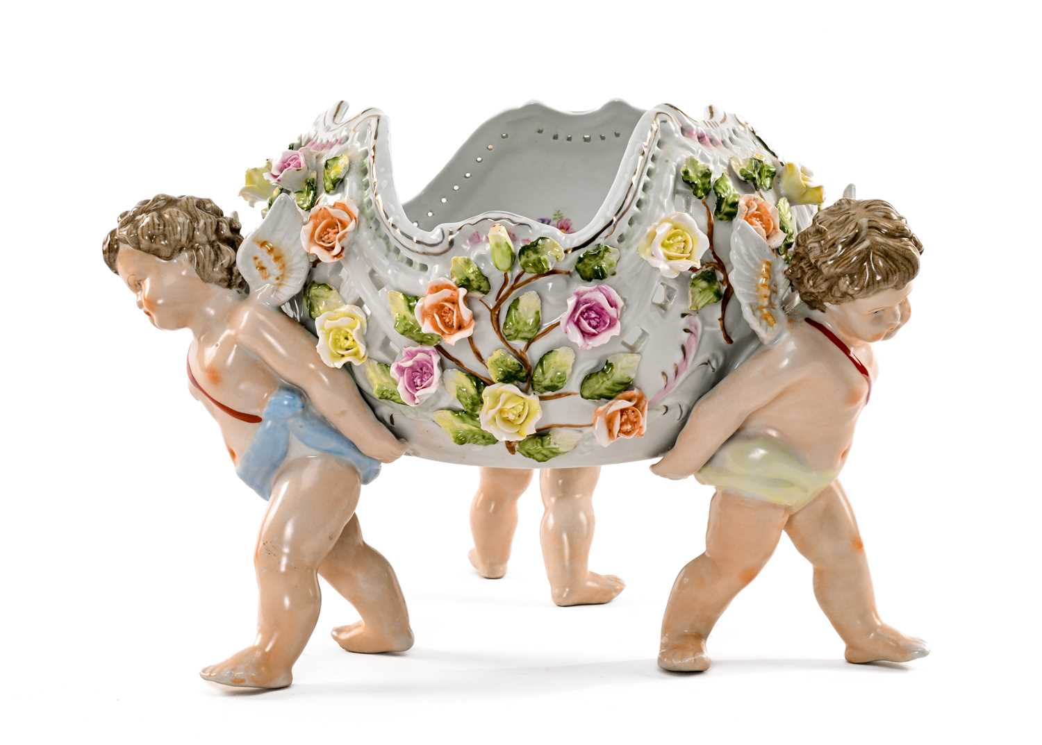 GERMAN PORCELAIN FIGURAL TABLE CENTREPIECE, the pierced, floral-encrusted bowl held by three