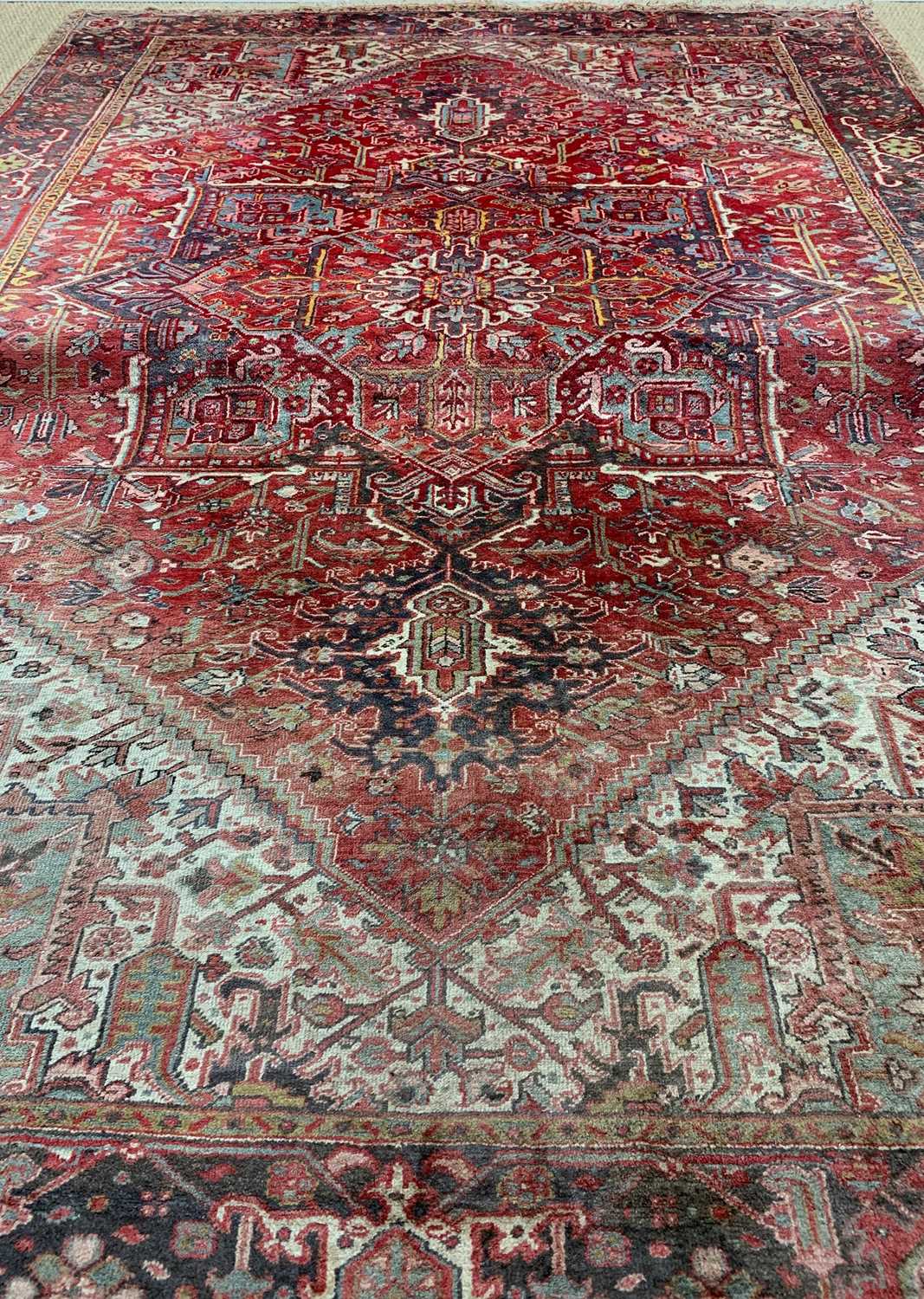 HERIZ CARPET, red lozenge serrated field and ivory/teal spandrels, broad dark border, 412 x 289cms