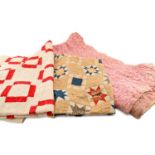 THREE WELSH QUILTS, one red/white, one multicoloured, and a pink floral (3) Provenance: collection