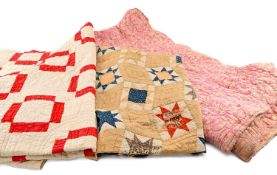 THREE WELSH QUILTS, one red/white, one multicoloured, and a pink floral (3) Provenance: collection