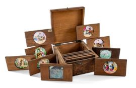 BOXED VICTORIAN MAGIC LANTERN SLIDES, coloured circular glass slides in mahognay frames,