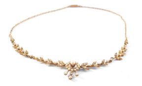 15CT GOLD SEED PEARL NECKLACE, of flower head and foliate design, 34cms long, 8.7gms Provenance: