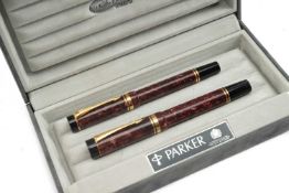 PARKER PEN SET, comprising pair marbled burgundy Parker Duofold Centennial rollerball and fountain