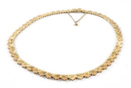 14CT TWO-COLOUR GOLD NECKLACE, bright-cut floral hinged folite links, clasp stamped 585, 44cms long,