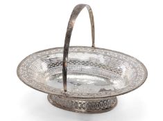 GEORGE III SILVER SWING-HANDLE SWEETMEAT / FRUIT BASKET, London 1818, of oval form with beaded edge,