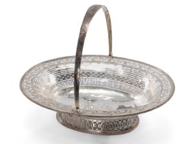 GEORGE III SILVER SWING-HANDLE SWEETMEAT / FRUIT BASKET, London 1818, of oval form with beaded edge,