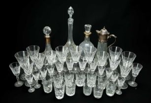 ASSORTED CUT GLASS TABLEWARE, including two silver-mounted decanters, a moulded glass claret jug,