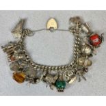 SILVER CHARM BRACELET WITH PADLOCK CLASP HOLDING 22 SILVER / WHITE METAL CHARMS including animals,