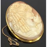 18CT GOLD FRAMED SHELL CARVED CAMEO BROOCH with head and shoulders depiction of a young woman,
