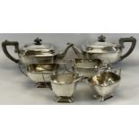 TWO SIMILAR ART DECO STYLE THREE-PIECE EPNS TEA SETS, each comprising teapot, 30cms across, milk jug