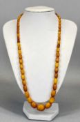VINTAGE AMBER BEAD NECKLACE OF 58 GRADUATING BEADS, 17mm across (the largest), 6mm across (the