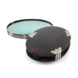 GEORGE III TORTOISESHELL POCKET LENS, with reeded white metal mounts, oval 10.2cm wide Provenance: