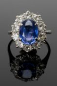 SAPPHIRE & DIAMOND CLUSTER RING, centre stone 8 x 10mm, within ten 0.1ct diamonds, unmarked white