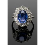 SAPPHIRE & DIAMOND CLUSTER RING, centre stone 8 x 10mm, within ten 0.1ct diamonds, unmarked white