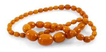 GRADUATED STRING OF OVAL BUTTERSCOTCH AMBER BEADS, 61cms long Provenance: private collection