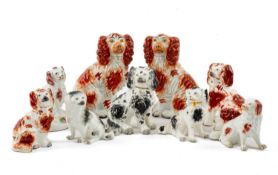 ASSORTED STAFFORDSHIRE MODEL SPANIELS, including an early pearlware dog seated on domed base with
