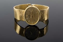 18CT GOLD BAUME & MERCIER 'BAUMATIC' WRISTWATCH, the oval dial with baton hour markers, date