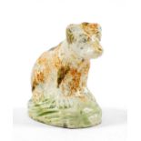 RARE PRATT-TYPE PEARLWARE MODEL OF A BEAR, c. 1820, wearing a collar and seated on grassy mound