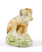 RARE PRATT-TYPE PEARLWARE MODEL OF A BEAR, c. 1820, wearing a collar and seated on grassy mound