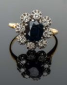 YELLOW METAL SAPPHIRE & DIAMOND CLUSTER RING, the central sapphire (8 x 9mms approx.) having