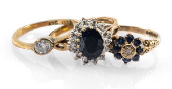 GOLD RINGS comprising two 9ct gold diamond and sapphire cluster rings, and a 9ct gold white stone