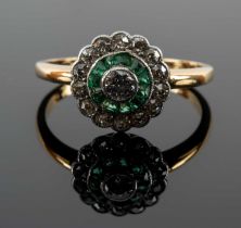 YELLOW METAL DIAMOND & EMERALD HALO RING, the shank engraved with initials and date '11.7.11',