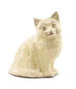 AN EWENNY SLIPWARE POTTERY MODEL OF A SEATED CAT circa 1900, in rarely seen cream coloured glaze,