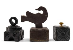 THREE 19TH CENTURY WELSH SLATE CARVINGS comprising (1) goose form doorstop on a square base,