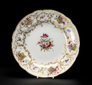 NANTGARW PORCELAIN PLATE circa 1818-1820, having twelve unequal lobes, painted in London with the '
