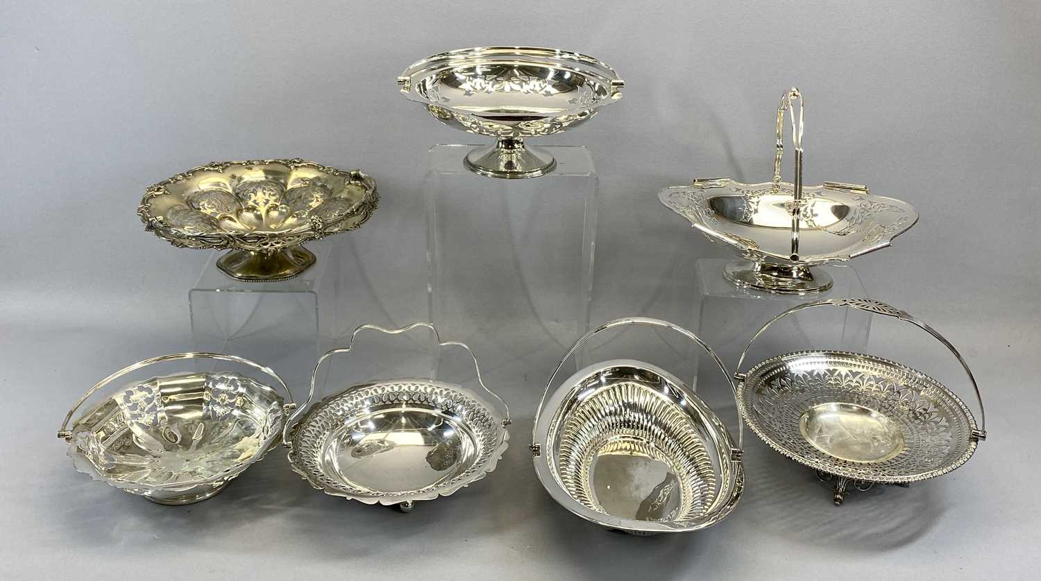 SEVEN VARIOUS SILVER PLATED SWING-HANDLED FRUIT / BREAD BASKETS, various designs, most having