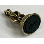 VICTORIAN GOLD SEAL FOB, the hardstone inset carved with arm holding a calliper type compass,