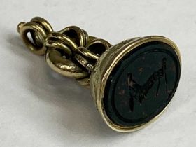 VICTORIAN GOLD SEAL FOB, the hardstone inset carved with arm holding a calliper type compass,