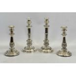 TWO PAIRS OF EPNS CANDLESTICKS, extending type and fixed, both having embossed decorations on loaded