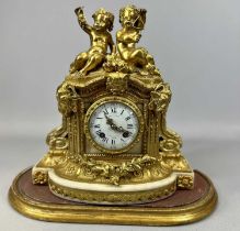19TH CENTURY FRENCH GILDED BRONZE MANTEL CLOCK, the case surmounted with figures of two putti, one